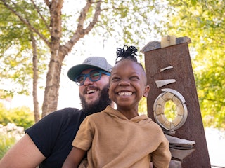 a little girl and her father having fun outdoors in Little Rock