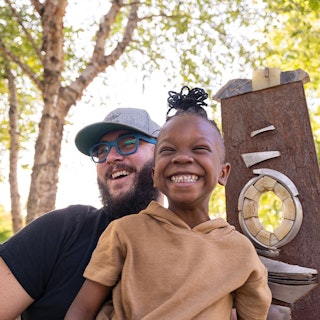 a little girl and her father having fun outdoors in Little Rock